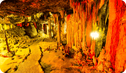 stalagmites and stalactites flooded in colored lights